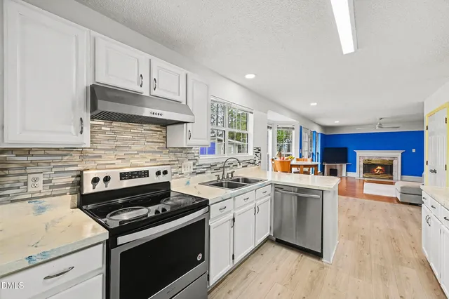 a kitchen with a sink stove and cabinets