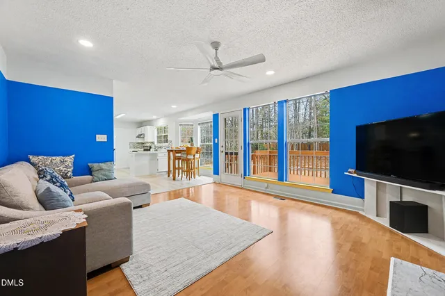 a kitchen with stainless steel appliances kitchen island granite countertop a dining table chairs and granite counter tops