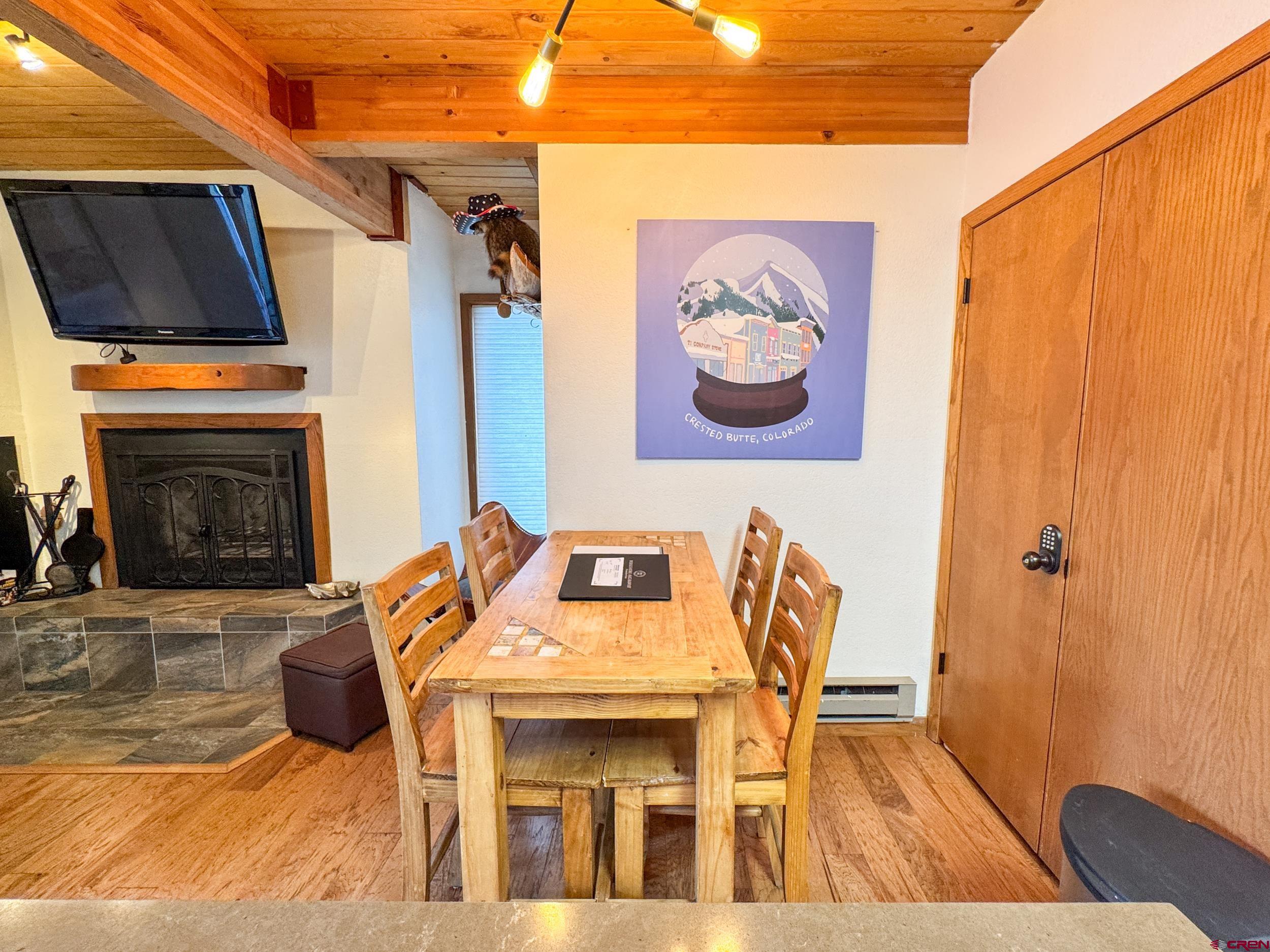 400 Gothic Road, Unit 305 Crested Butte, CO 81225 - Photo 6 of 38 a view of a dining room with furniture and a fireplace
