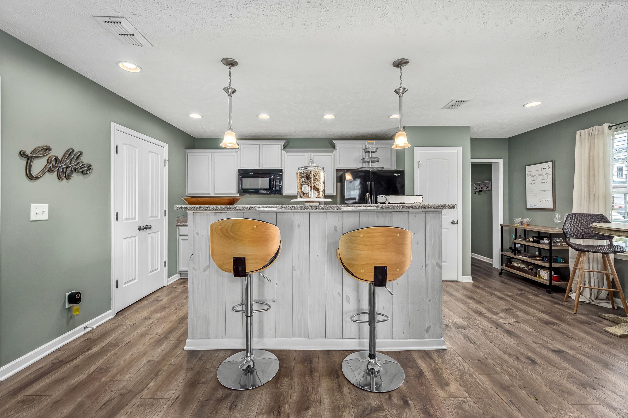 4720 Chelanie Circle Murfreesboro, TN 37129 - Photo 17 of 31 a kitchen with stainless steel appliances granite countertop a refrigerator a stove a sink dishwasher and a dining table with wooden floor