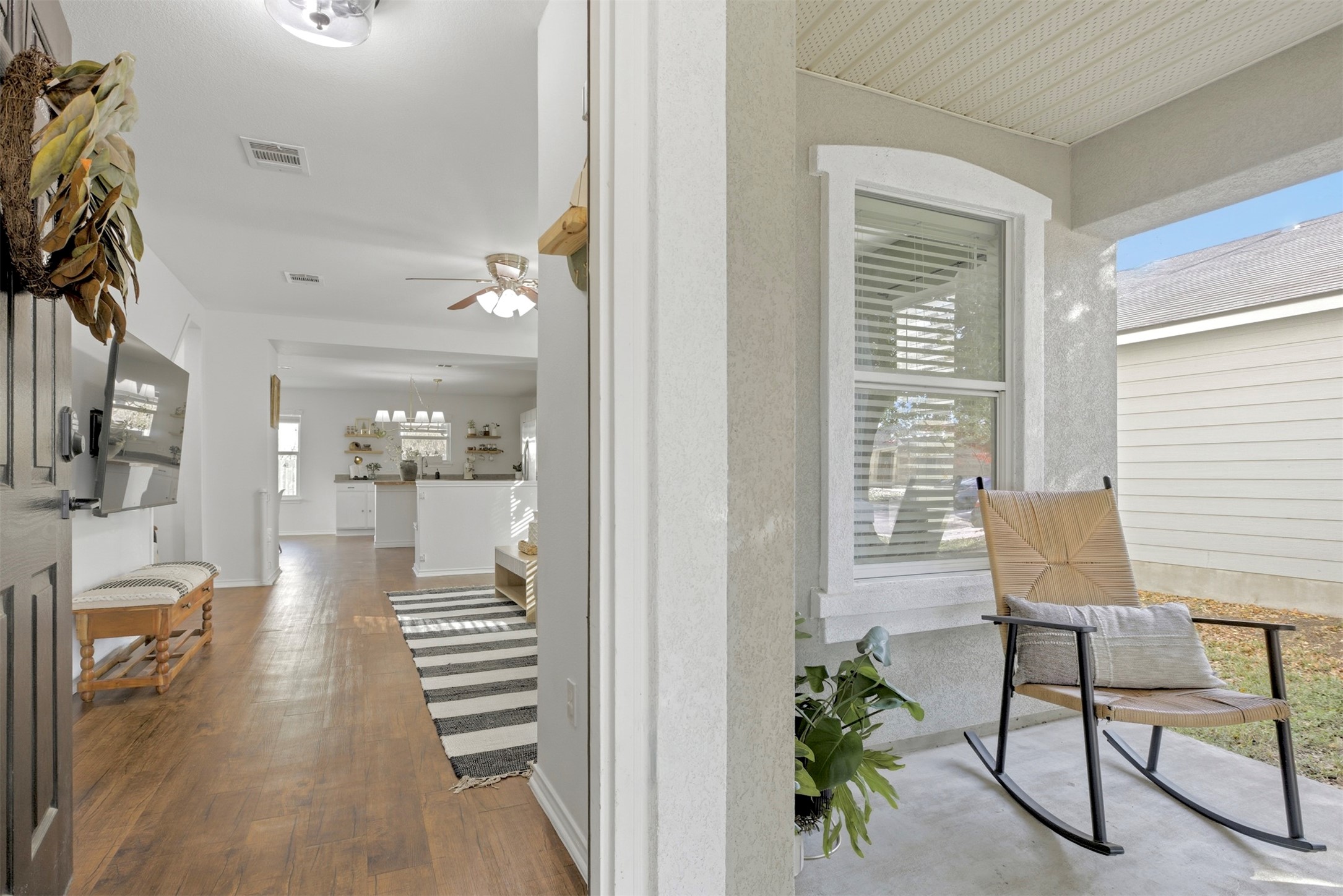 Bright entryway featuring warm wood flooring.