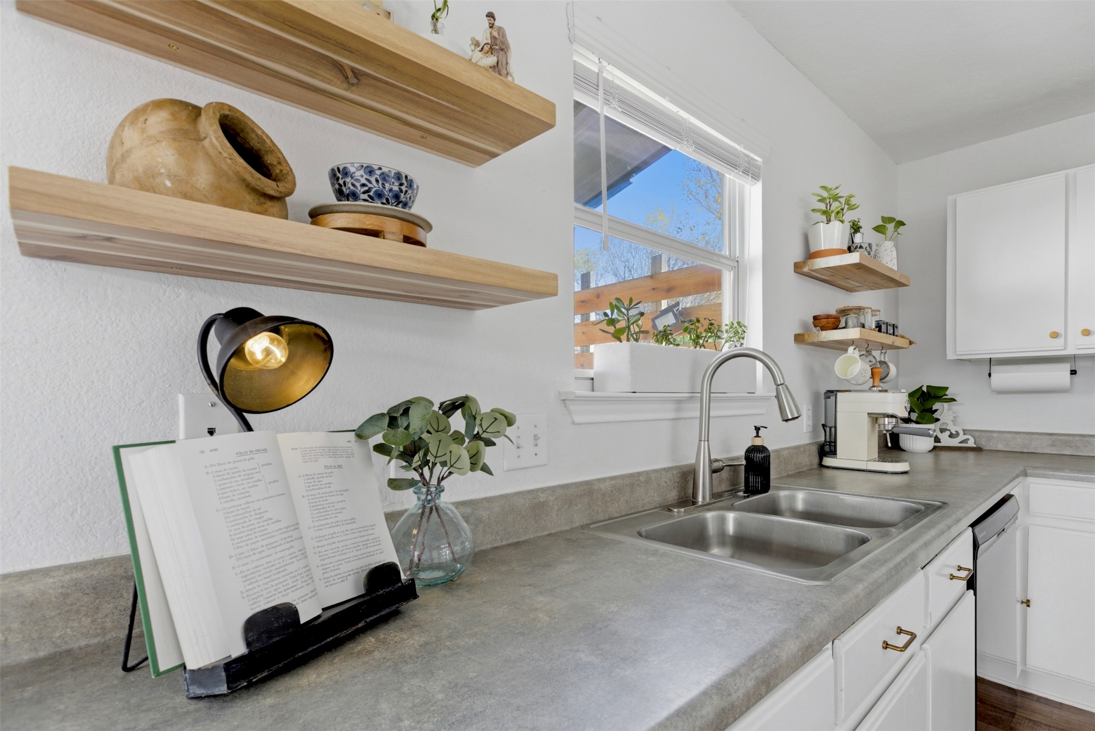 75 Jan Lane Georgetown, TX 78626 - Photo 11 of 32 Kitchen sink area with window views, modern faucet, and charming coffee station.