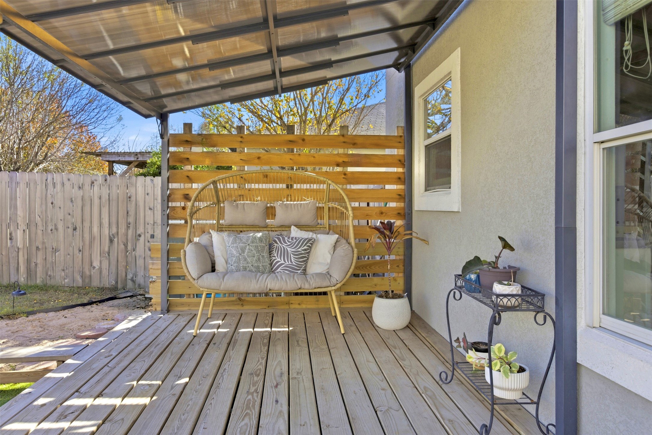 75 Jan Lane Georgetown, TX 78626 - Photo 29 of 32 Rear exterior showcasing covered patio areas, deck space, shade sail, and turf yard—ideal for outdoor living and entertaining.