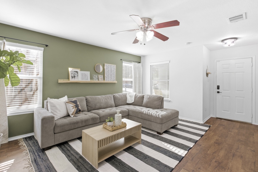 75 Jan Lane Georgetown, TX 78626 - Photo 8 of 32 Spacious living area with accent wall, abundant natural light, and flexible furniture layout.