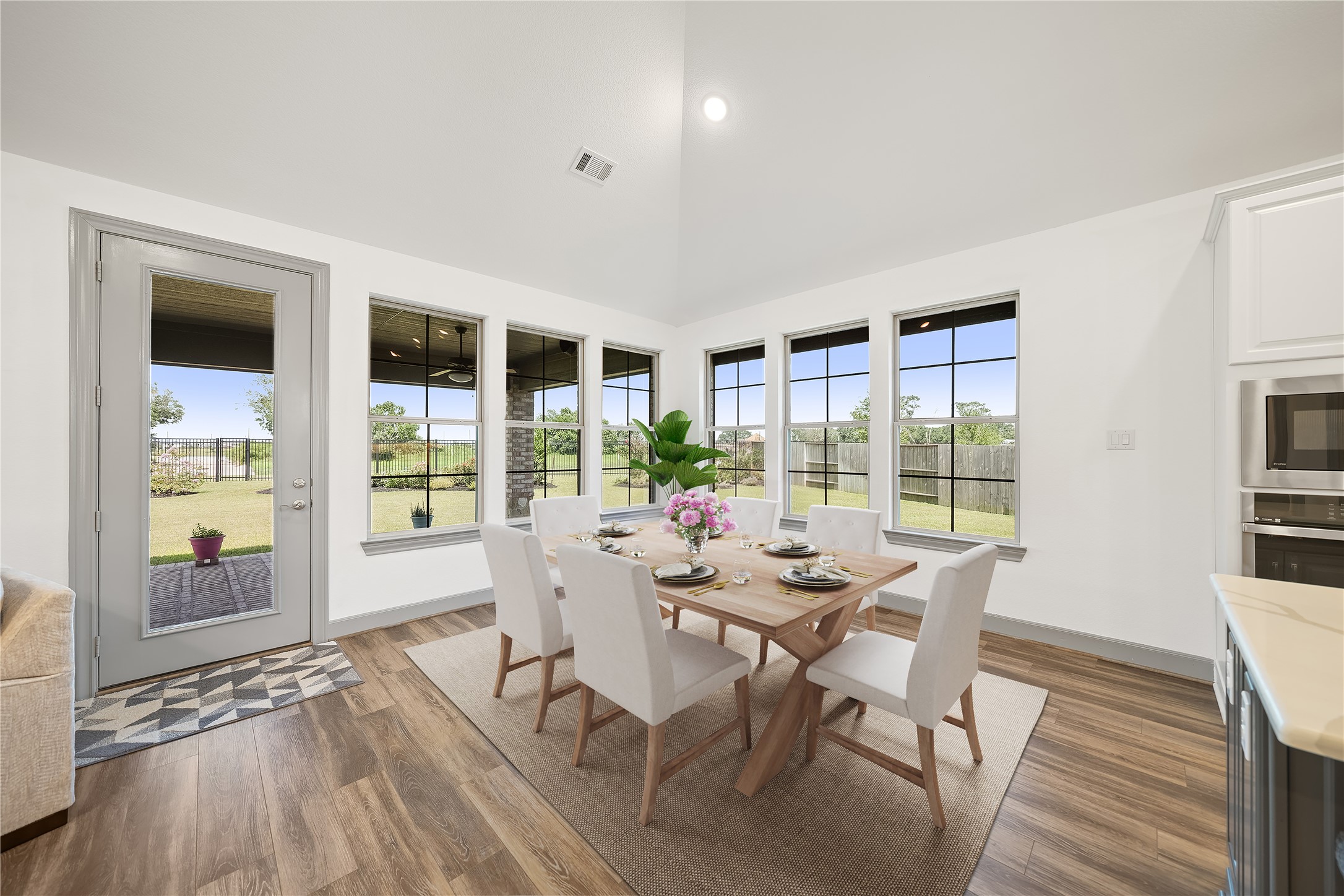 5739 Bobwhite Trail Manvel, TX 77578 - Photo 11 of 29 A wall of windows frames backyard views while filling the dining area with sunlight. The nearby patio access makes indoor-outdoor entertaining effortless.