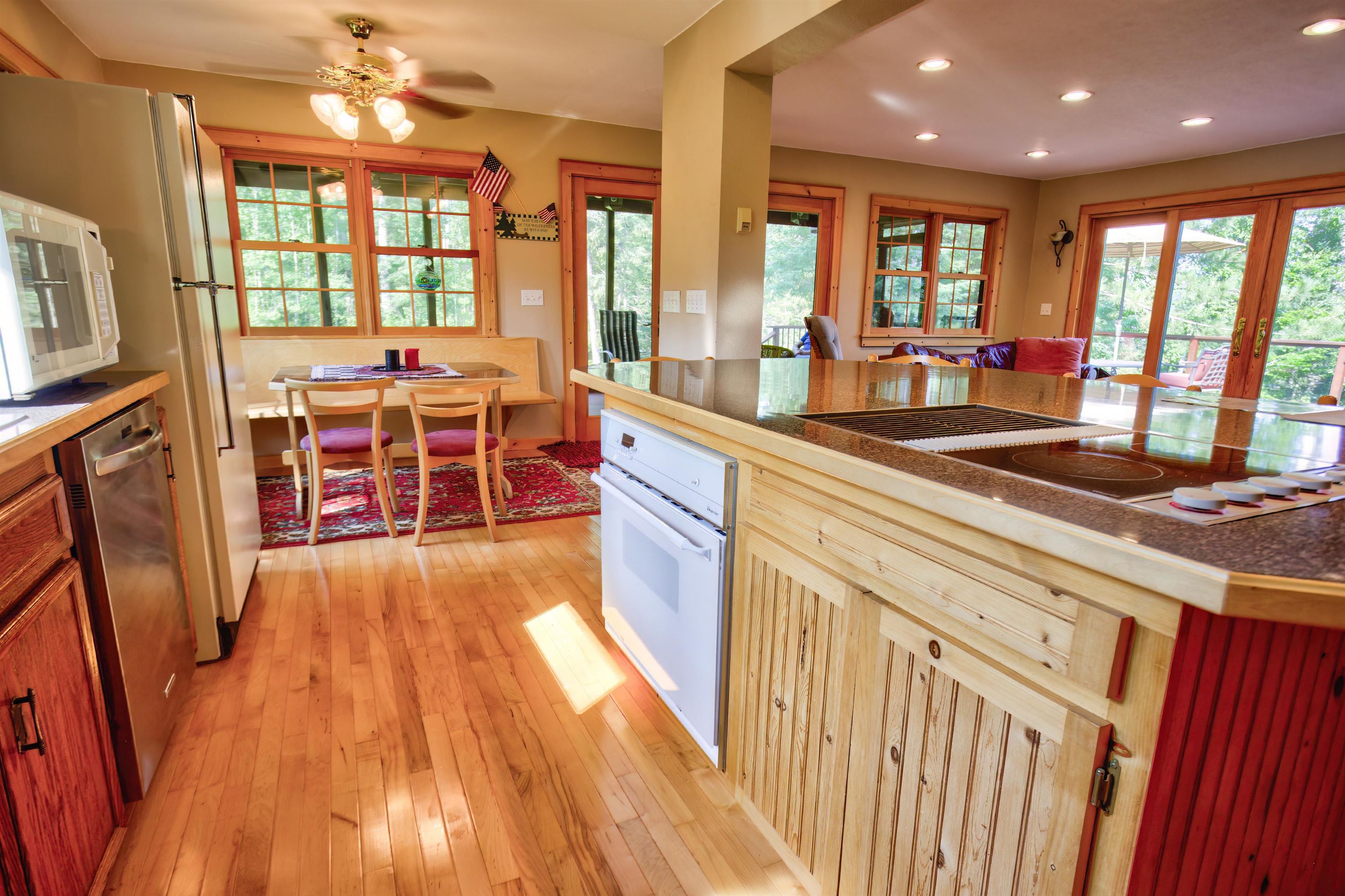12351 Endless Waters Road Ely, MN 55731 - Photo 25 of 48 Kitchen featuring light wood-type flooring, white appliances, plenty of natural light, and recessed lighting