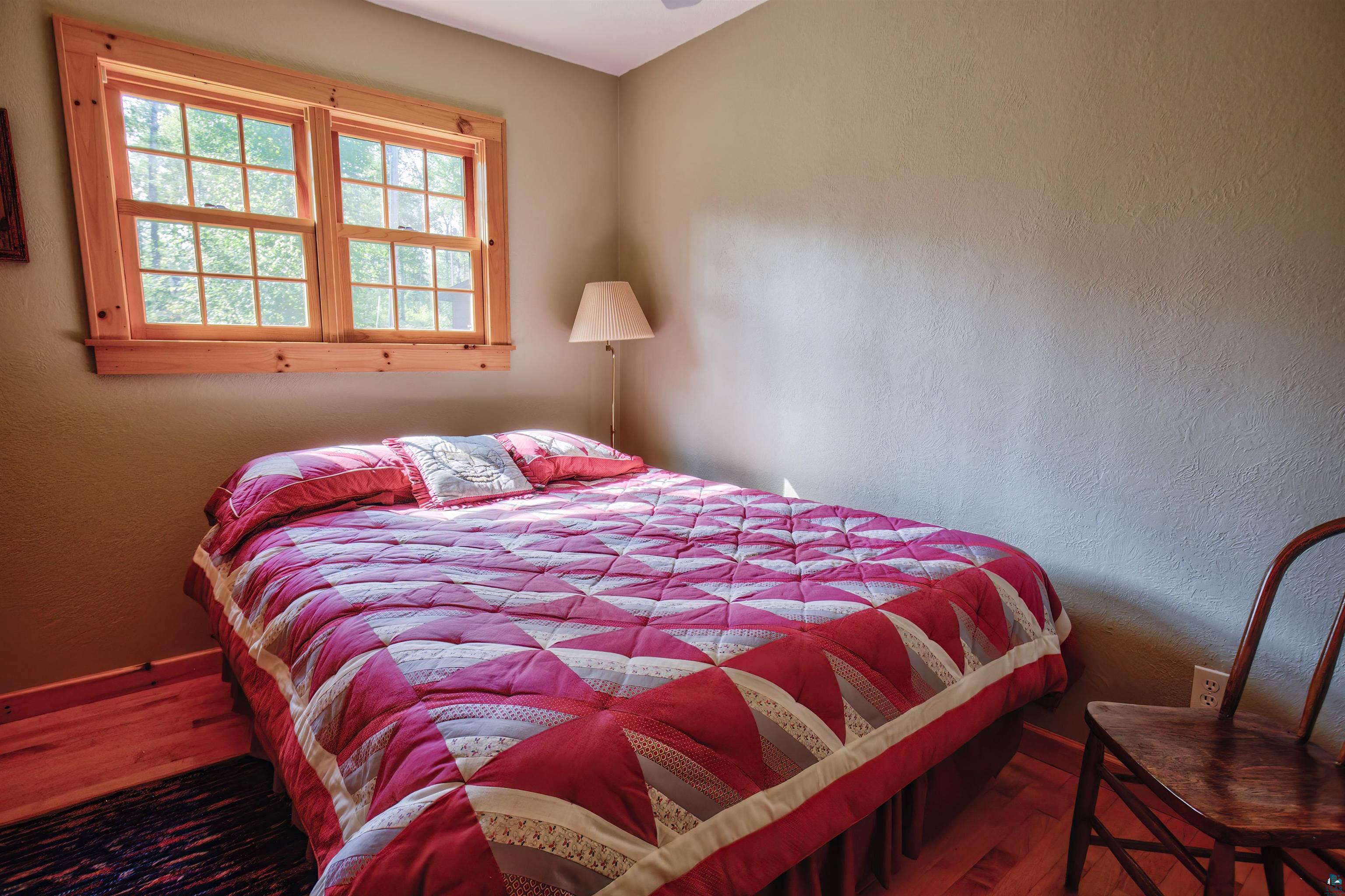 12351 Endless Waters Road Ely, MN 55731 - Photo 26 of 48 Bedroom featuring a textured wall and wood finished floors