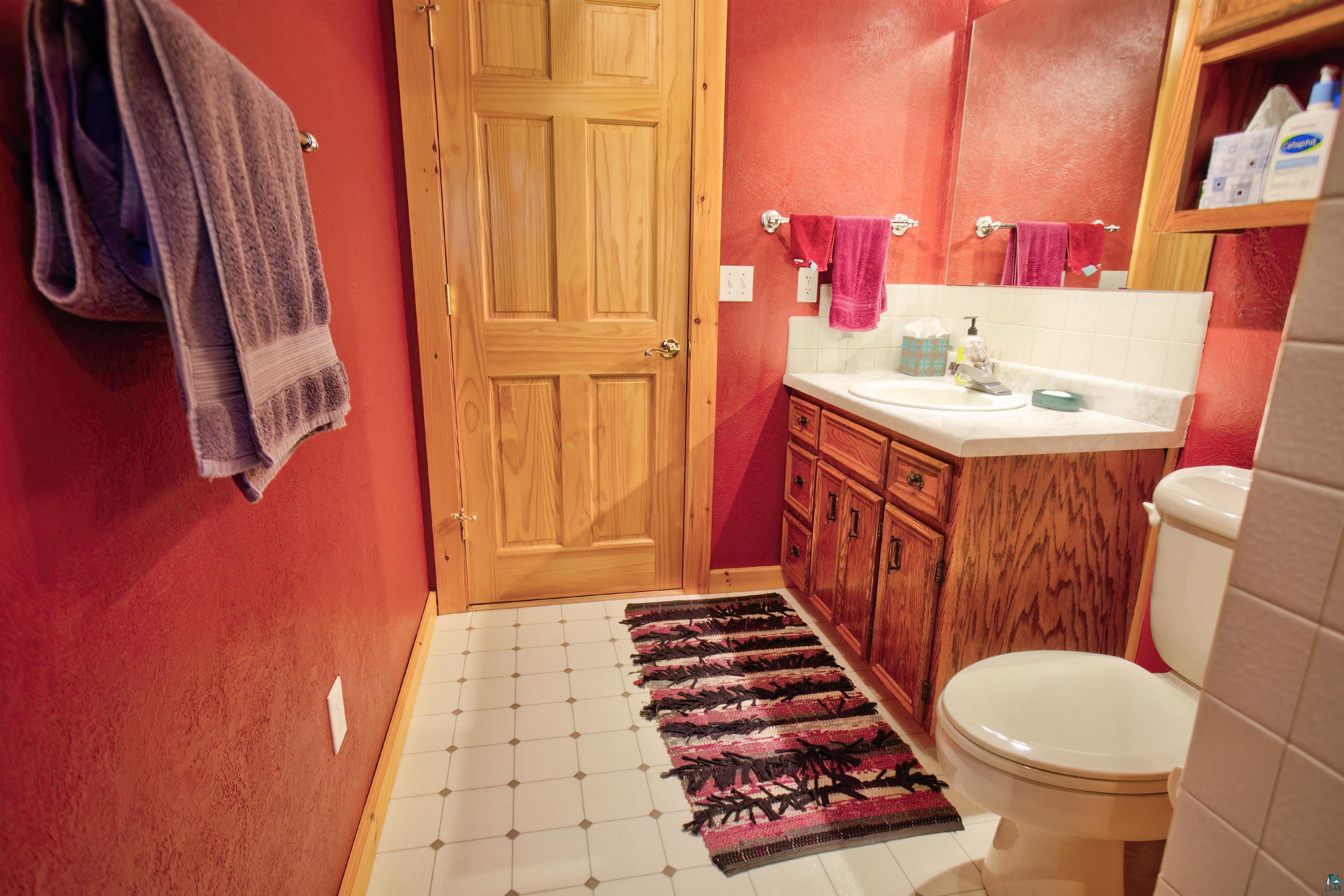 12351 Endless Waters Road Ely, MN 55731 - Photo 28 of 48 Bathroom with tile patterned floors, vanity, and a textured wall