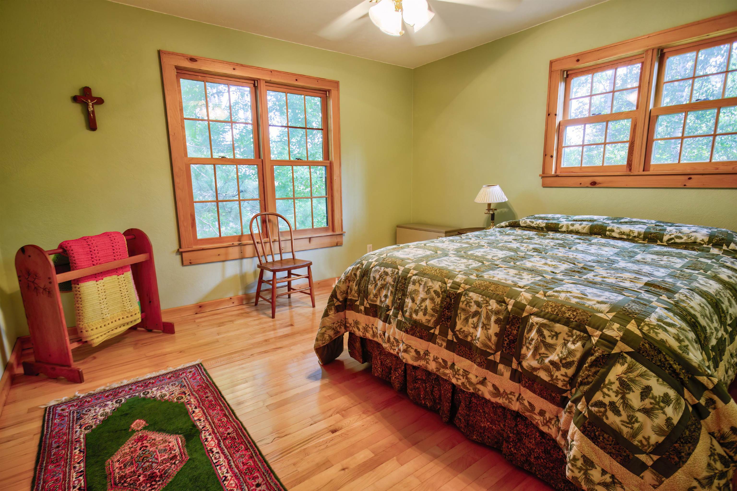 12351 Endless Waters Road Ely, MN 55731 - Photo 29 of 48 Bedroom featuring multiple windows, light wood-style floors, and a ceiling fan