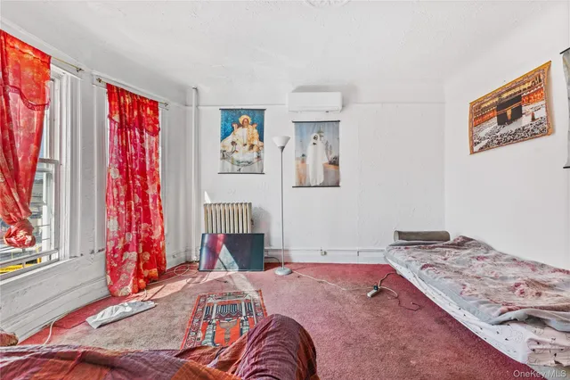 a bedroom with bed and a window