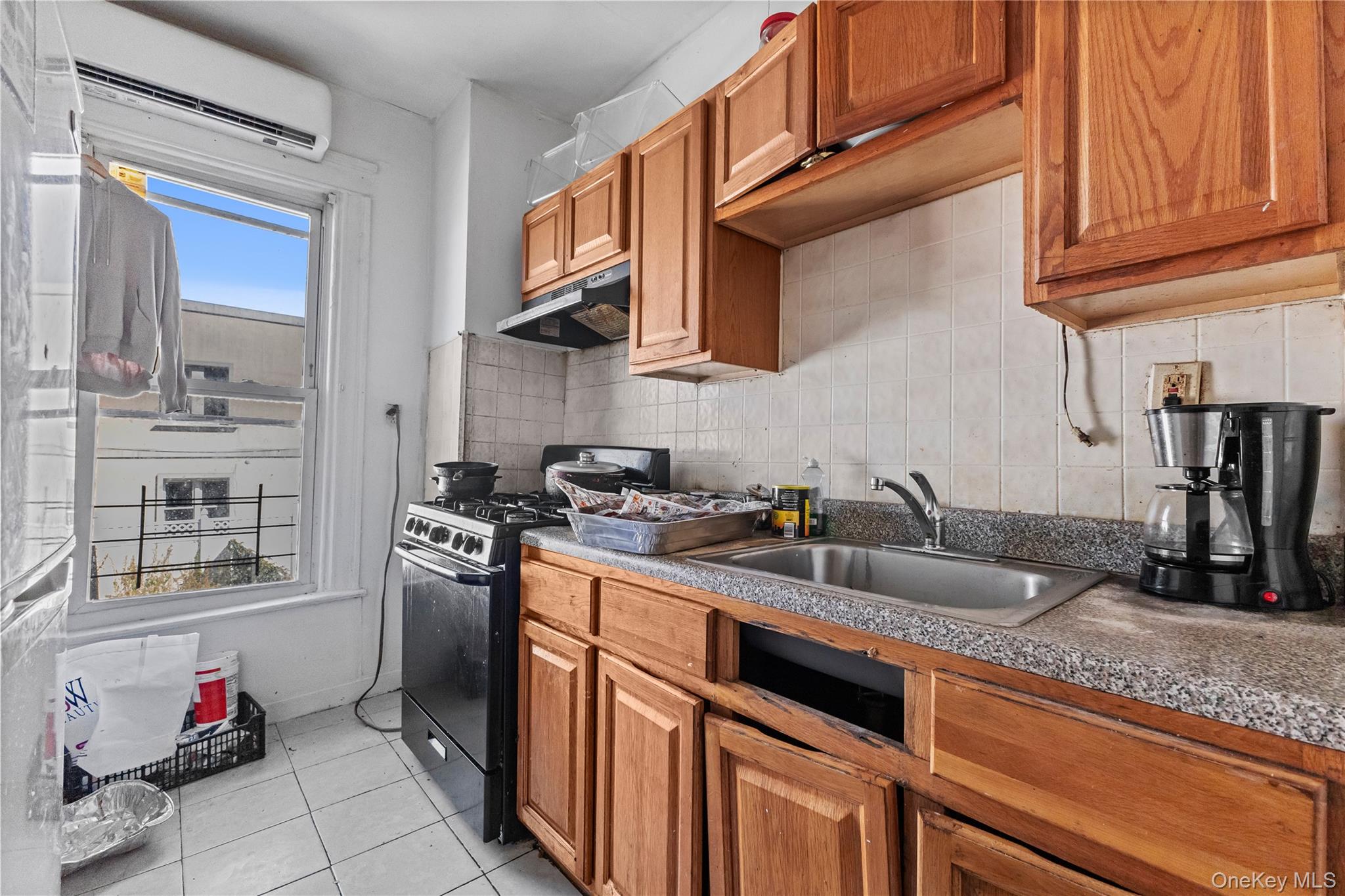 603 East 236th Street Bronx, NY 10466 - Photo 19 of 28 a kitchen with stainless steel appliances granite countertop a sink stove and cabinets