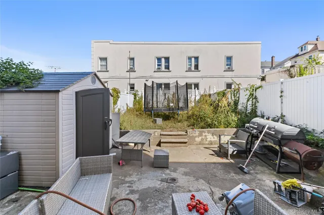 a view of a patio with table and chairs potted plants
