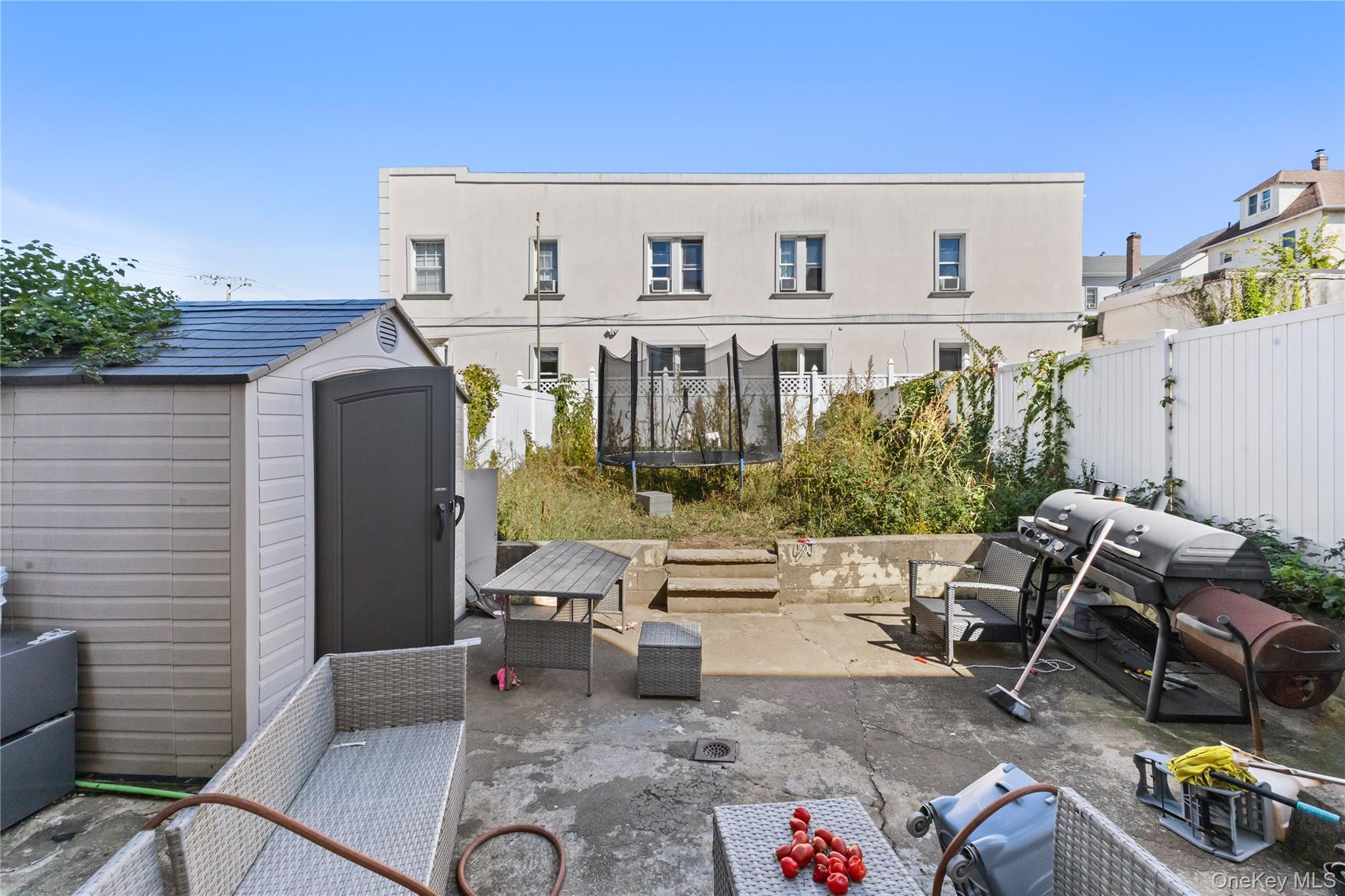603 East 236th Street Bronx, NY 10466 - Photo 24 of 28 a view of a patio with table and chairs potted plants