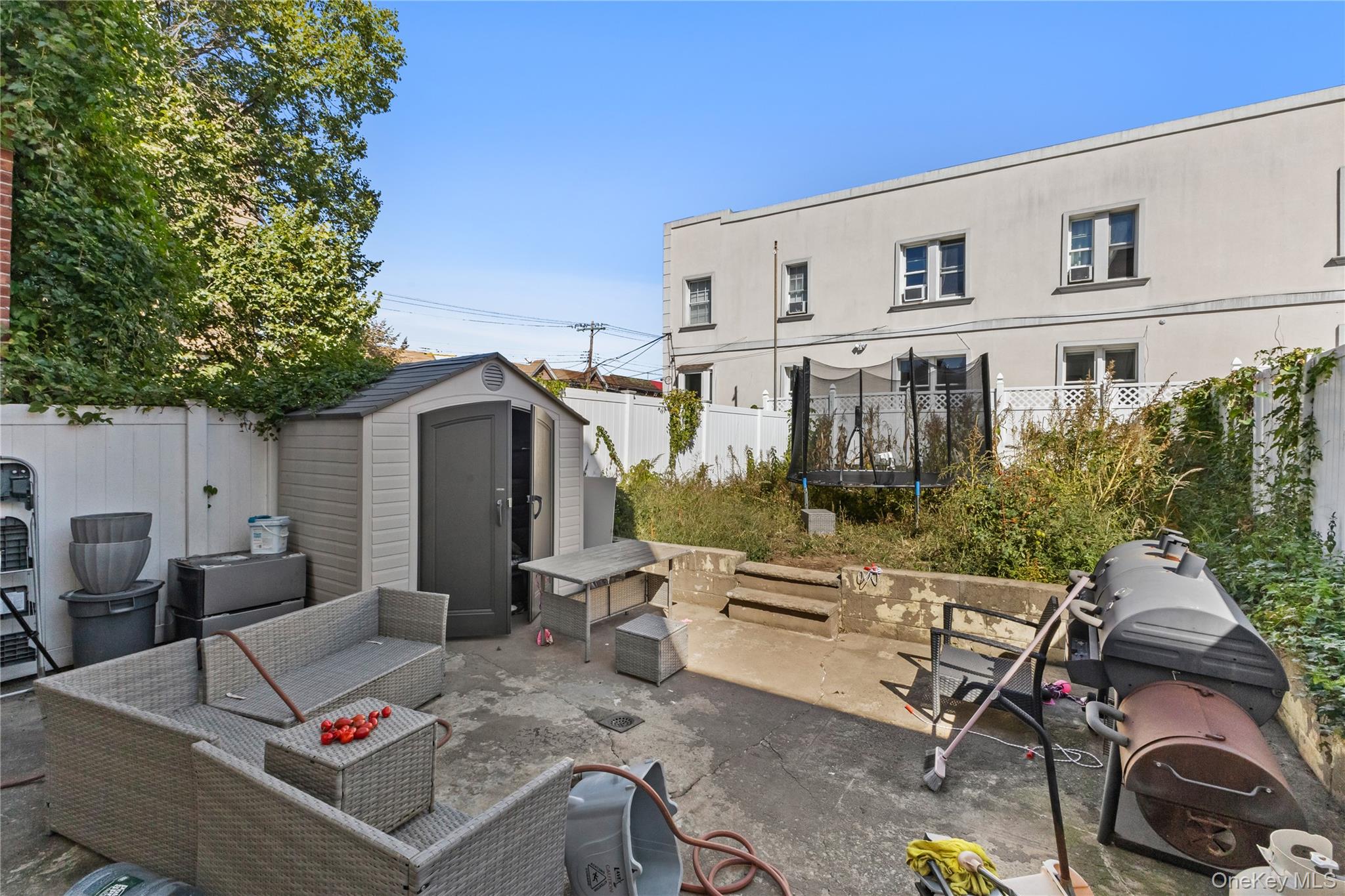 603 East 236th Street Bronx, NY 10466 - Photo 25 of 28 a view of a patio with table and chairs and potted plants