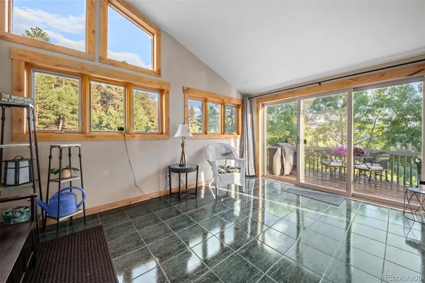 a view of a room with lots of windows and furniture