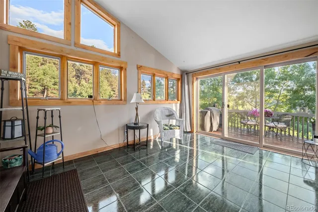 a view of a room with lots of windows and furniture