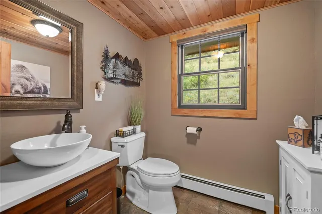 a bathroom with a toilet a sink and mirror