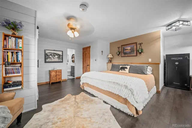 a bedroom with a bed furniture and a book shelf