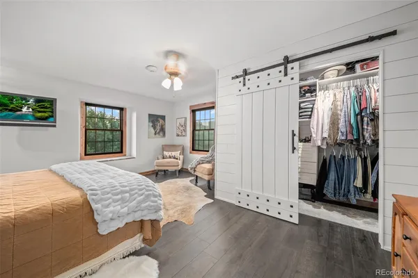 a spacious bedroom with a bed and a window