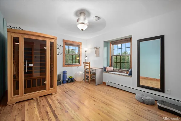 a very nice looking room with wooden floor and furniture
