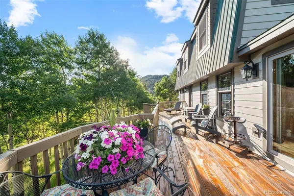 a view of a balcony with outdoor seating