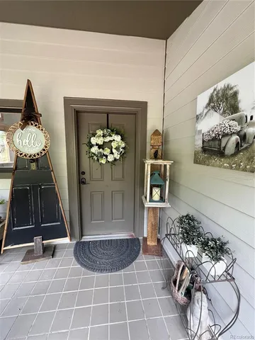 a living room with furniture a chandelier and a rug