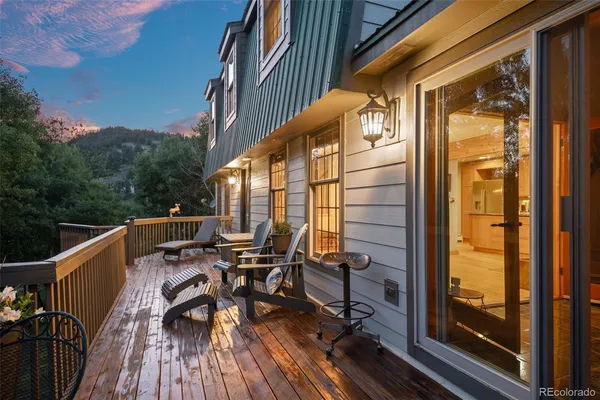 a view of balcony with chairs and wooden fence