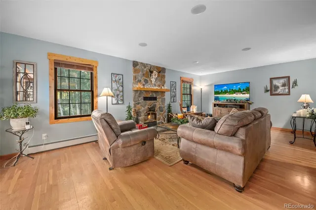 a living room with furniture window and a wooden floor