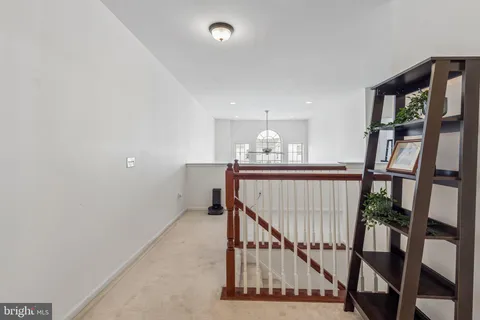 a view of staircase with white walls and a window