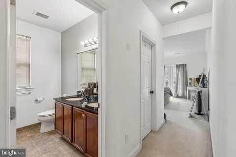 a view of a hallway with couch and closet
