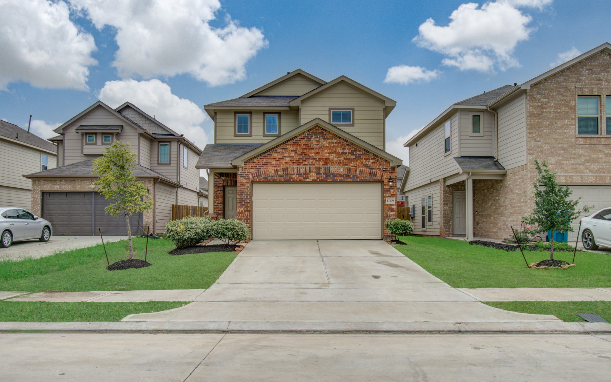 13309 Myrtle Meadows Lane Houston, TX 77048 - Photo 1 of 32 a front view of a house with a yard and garage