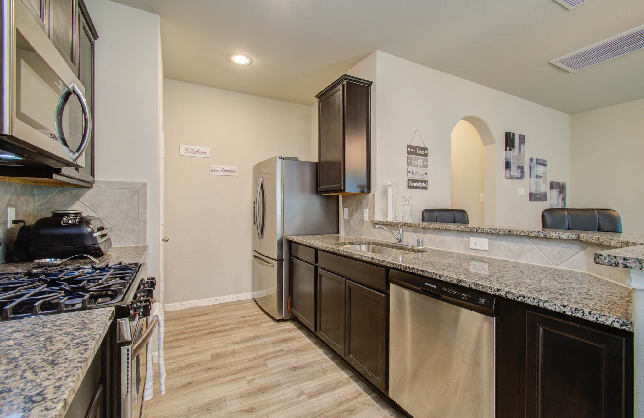 13309 Myrtle Meadows Lane Houston, TX 77048 - Photo 11 of 32 a kitchen with stainless steel appliances granite countertop a sink stove and refrigerator