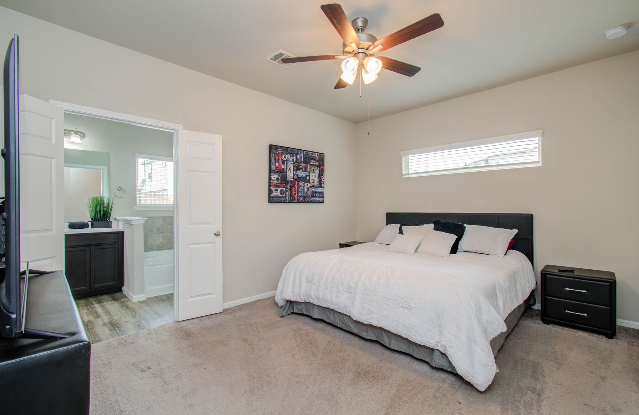 13309 Myrtle Meadows Lane Houston, TX 77048 - Photo 15 of 32 a bedroom with a bed and a chandelier