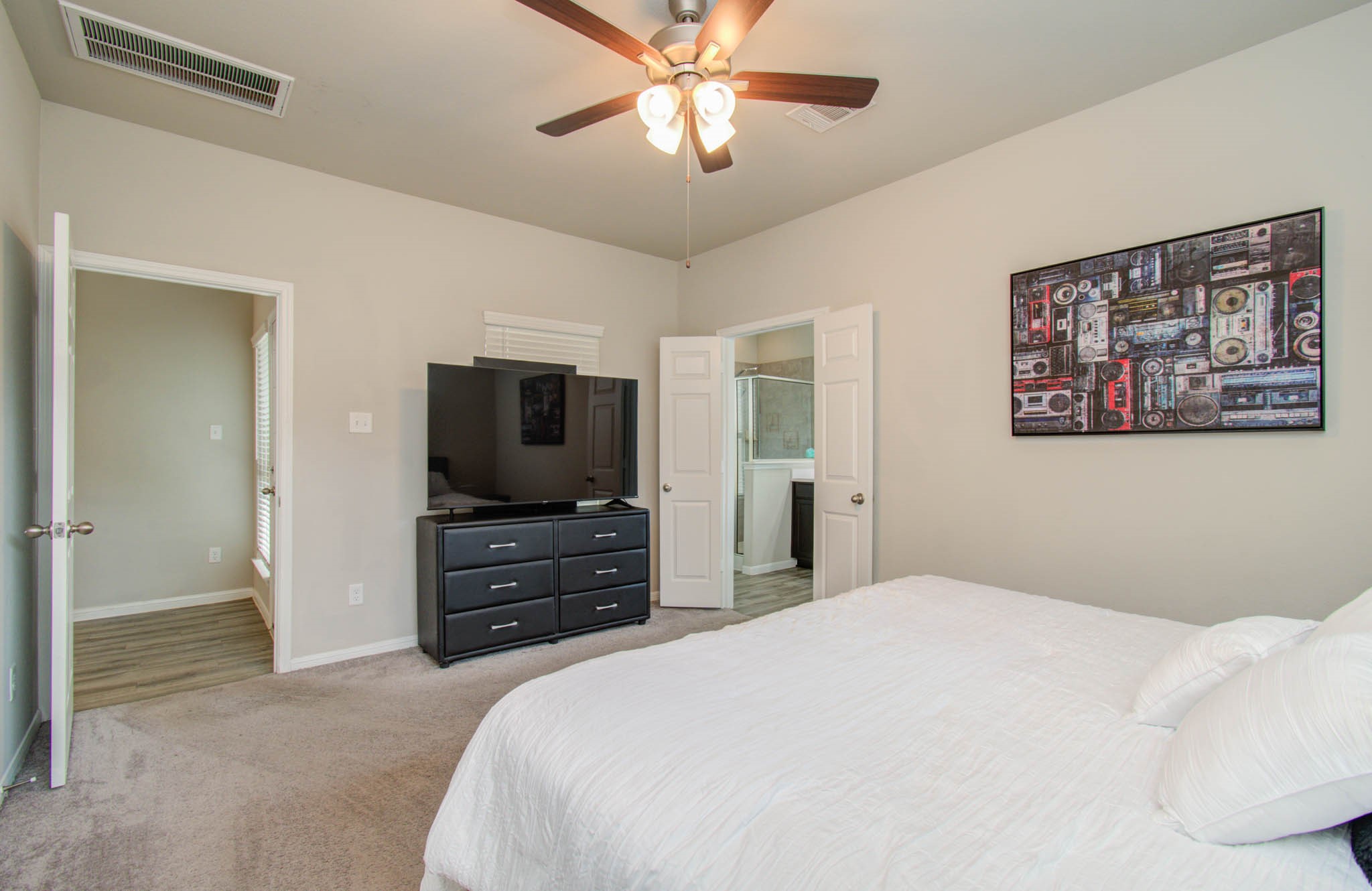 13309 Myrtle Meadows Lane Houston, TX 77048 - Photo 16 of 32 a bedroom with a bed and a flat screen tv