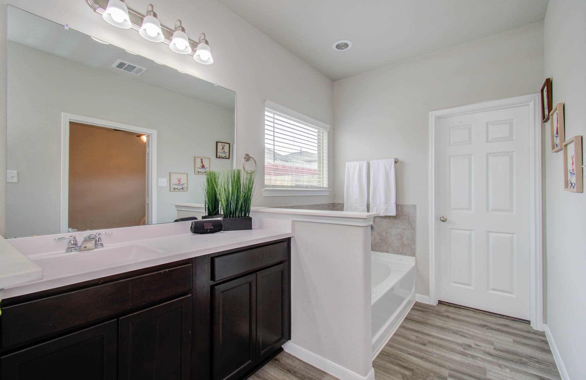 13309 Myrtle Meadows Lane Houston, TX 77048 - Photo 18 of 32 a bathroom with a double vanity sink and a mirror