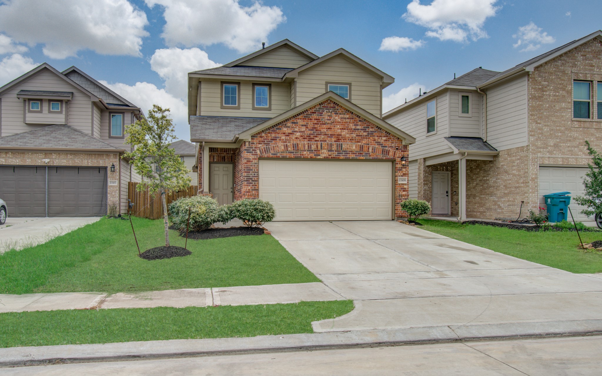 13309 Myrtle Meadows Lane Houston, TX 77048 - Photo 2 of 32 a front view of a house with a yard and garage