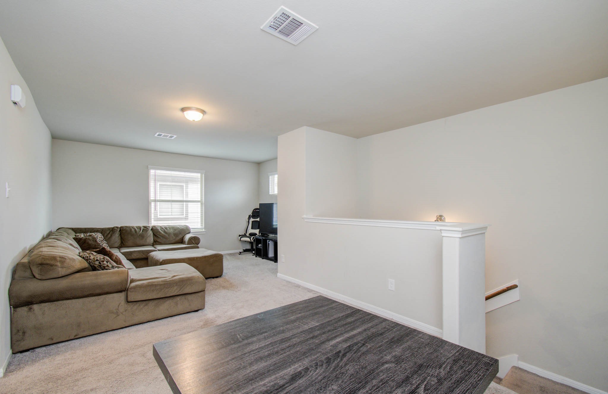 13309 Myrtle Meadows Lane Houston, TX 77048 - Photo 21 of 32 a living room with furniture and a window