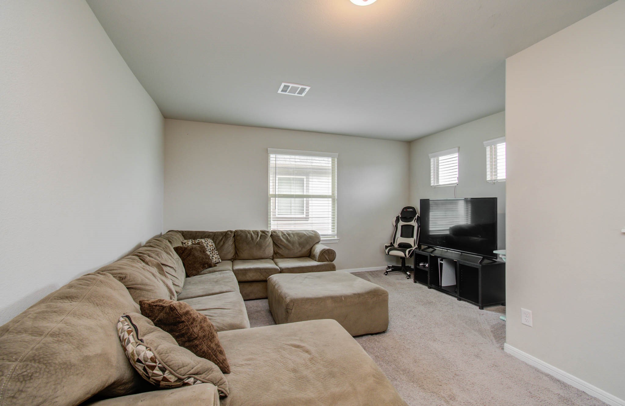 13309 Myrtle Meadows Lane Houston, TX 77048 - Photo 22 of 32 a living room with furniture window and a flat screen tv