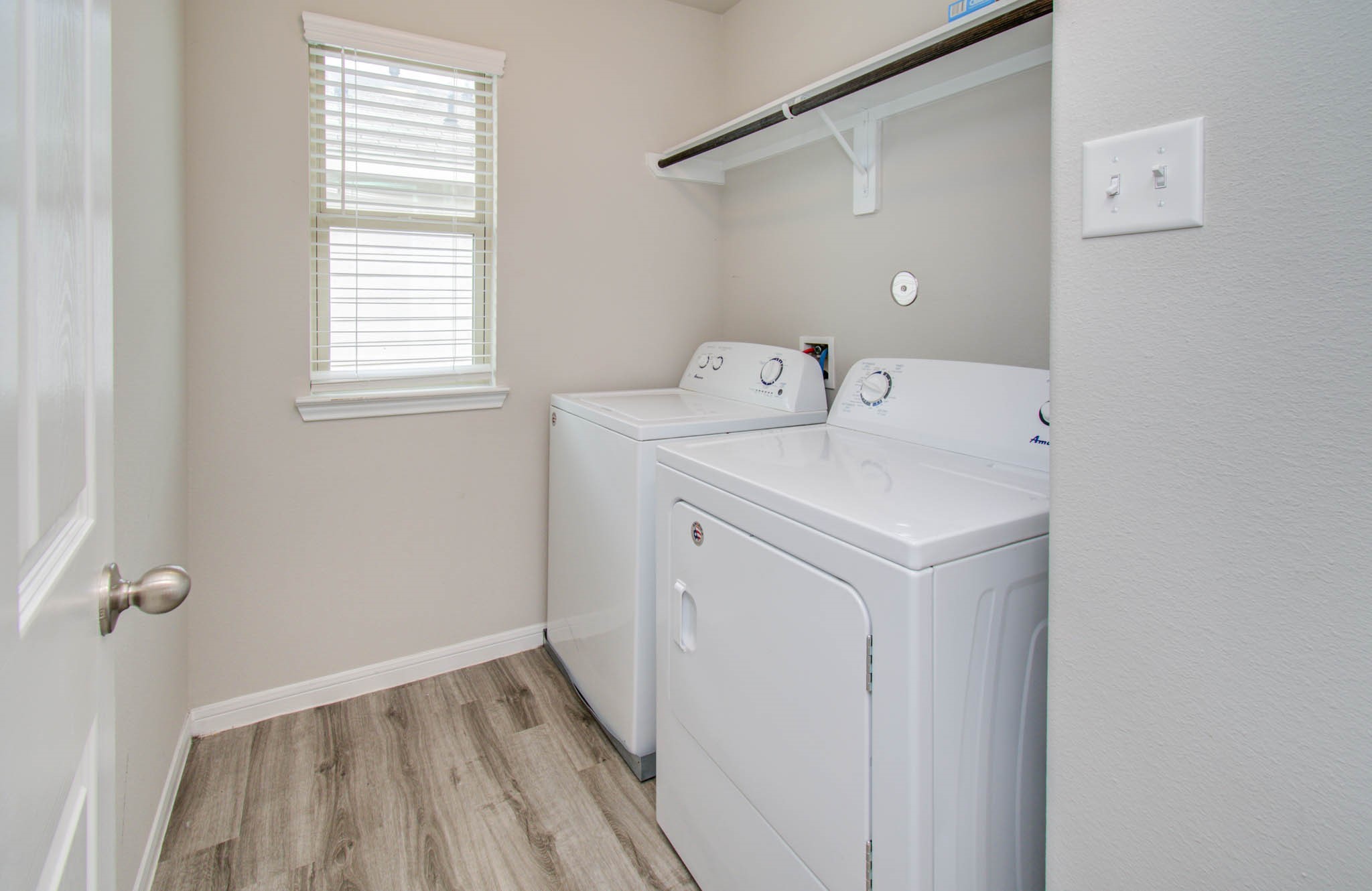 13309 Myrtle Meadows Lane Houston, TX 77048 - Photo 24 of 32 a utility room with a window dryer and washer