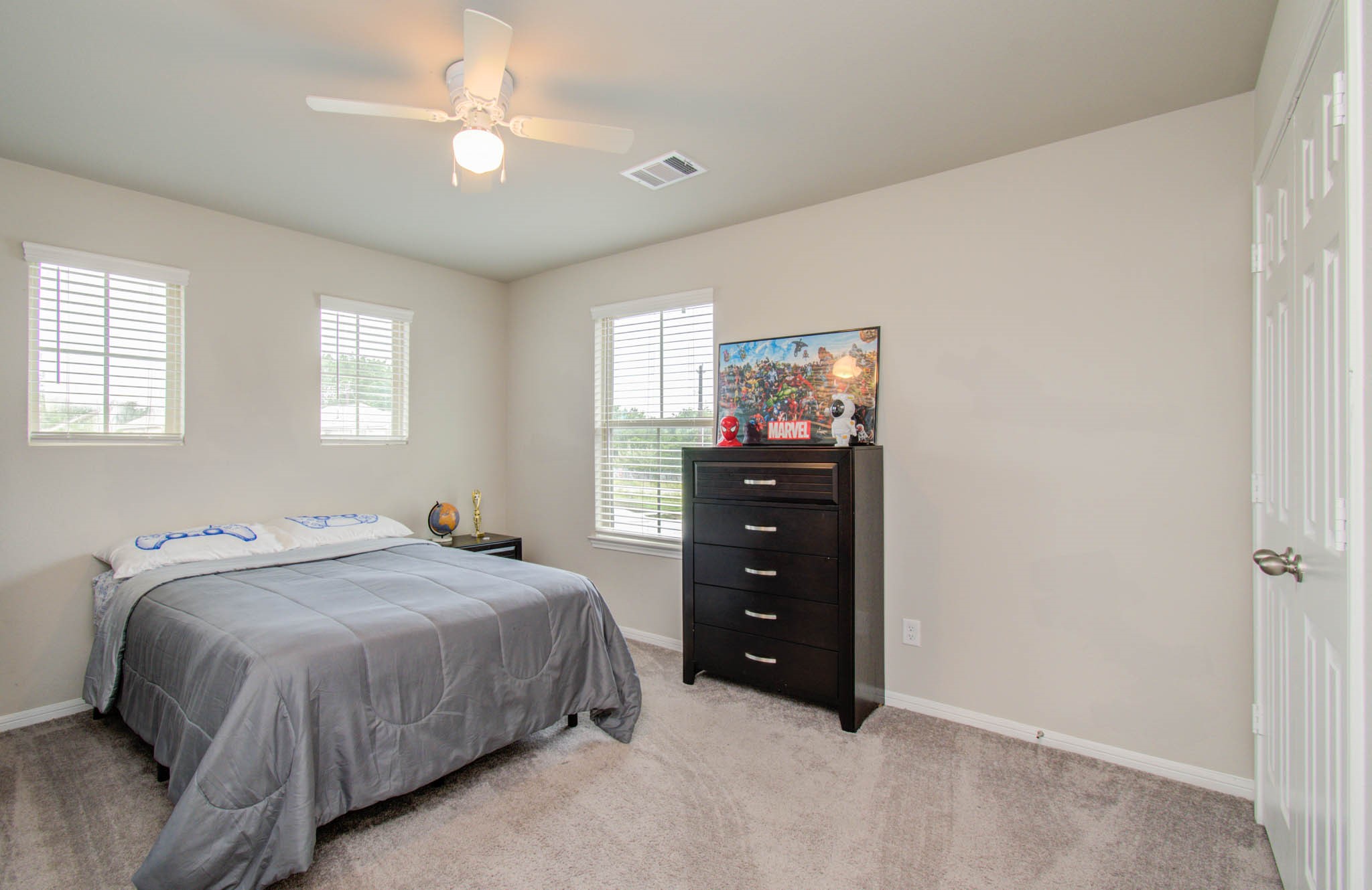 13309 Myrtle Meadows Lane Houston, TX 77048 - Photo 26 of 32 a bedroom with a bed and a chandelier
