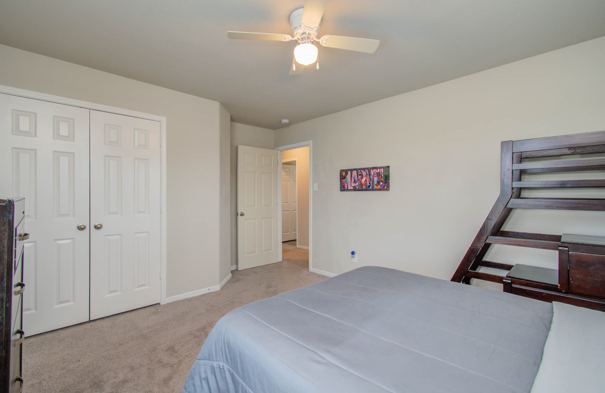 13309 Myrtle Meadows Lane Houston, TX 77048 - Photo 27 of 32 a bedroom with a bed and a ceiling fan