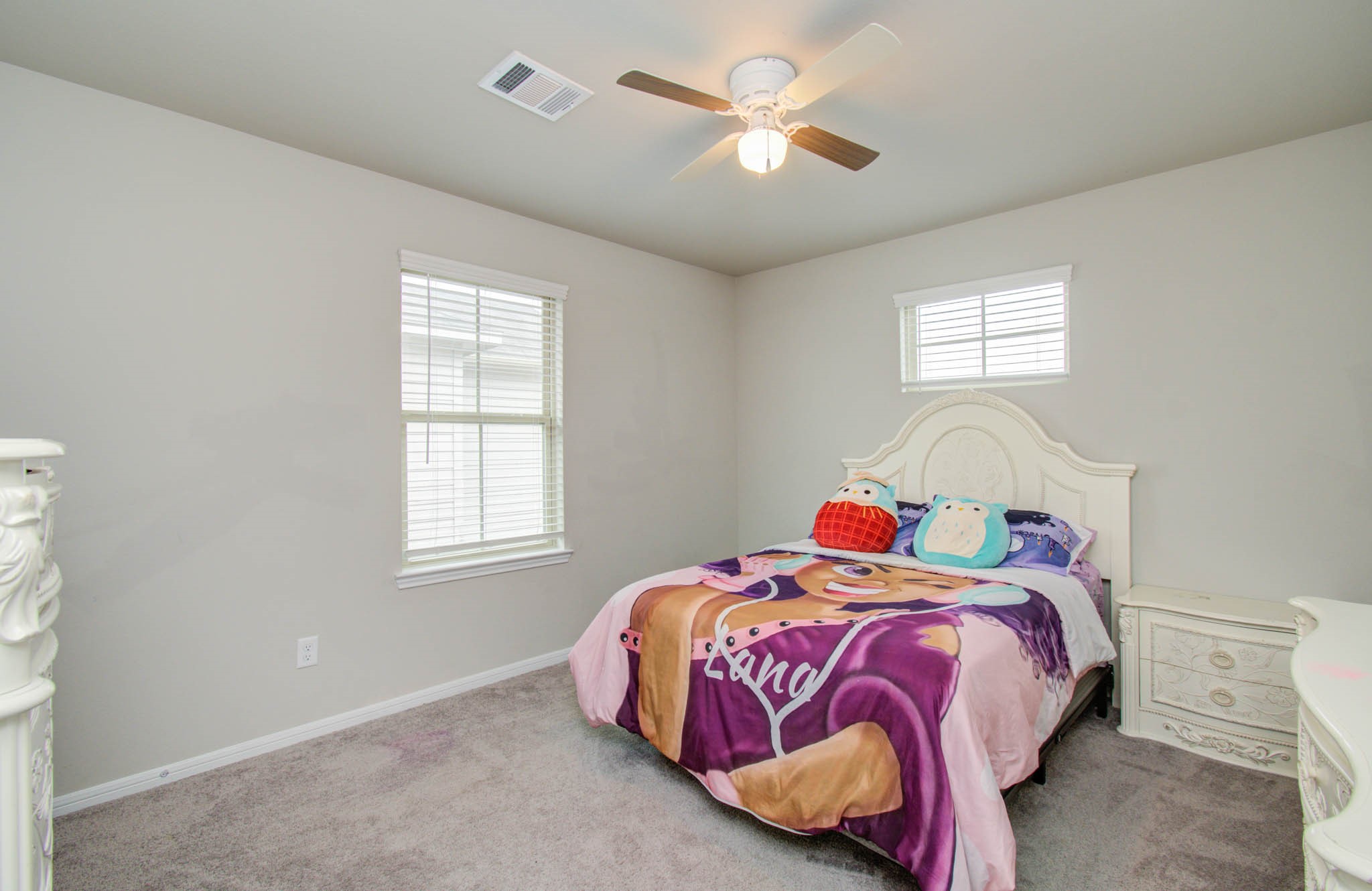 13309 Myrtle Meadows Lane Houston, TX 77048 - Photo 28 of 32 a bedroom with a bed and a chandelier