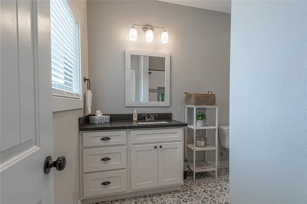 a bathroom with a glass shower door