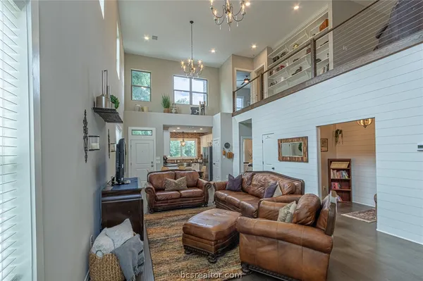 a living room with furniture and a chandelier