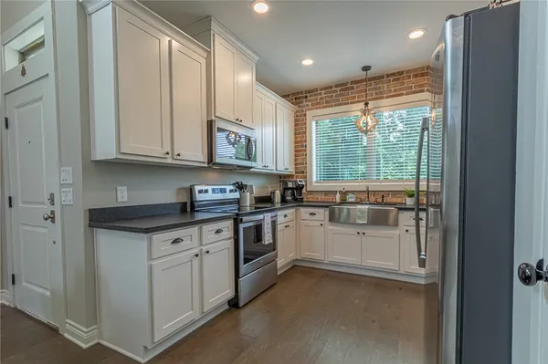 a kitchen with stainless steel appliances granite countertop a stove and a refrigerator