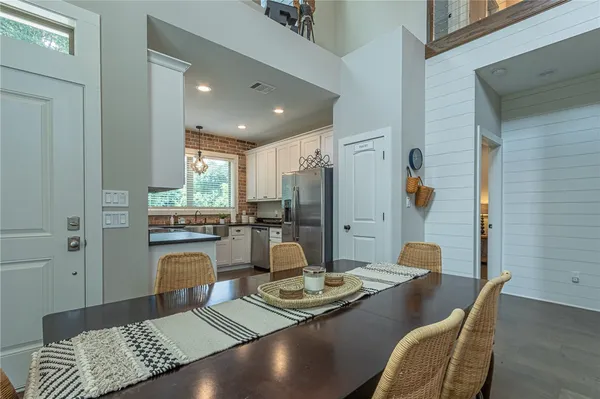 a living room with kitchen island furniture and a chandelier