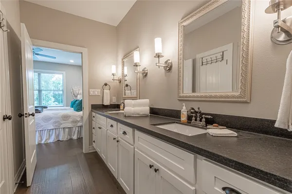 a bathroom with a double vanity sink and a mirror