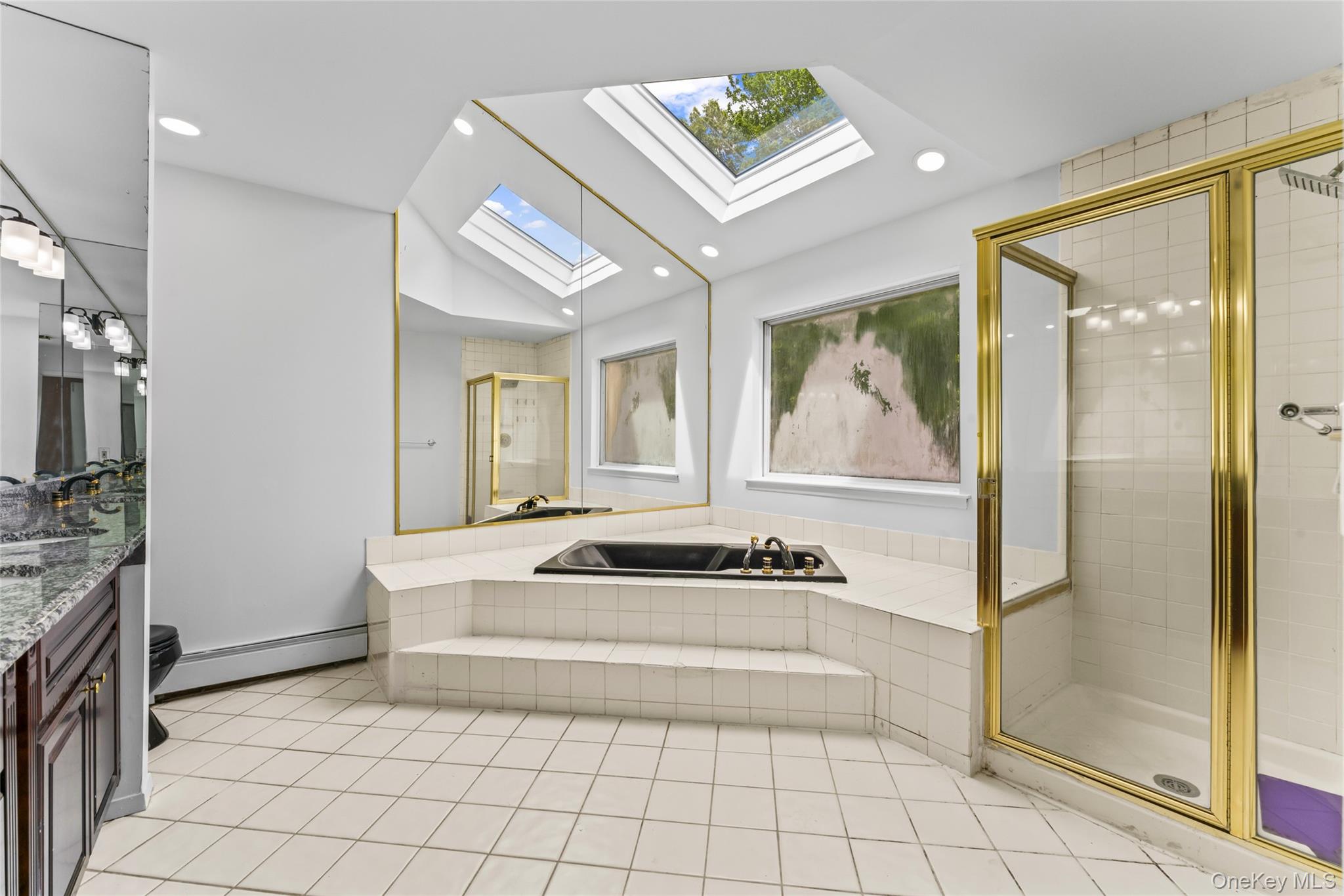 126 Bagatelle Road Melville, NY 11747 - Photo 33 of 50 a spacious bathroom with a mirror a bathtub and shower