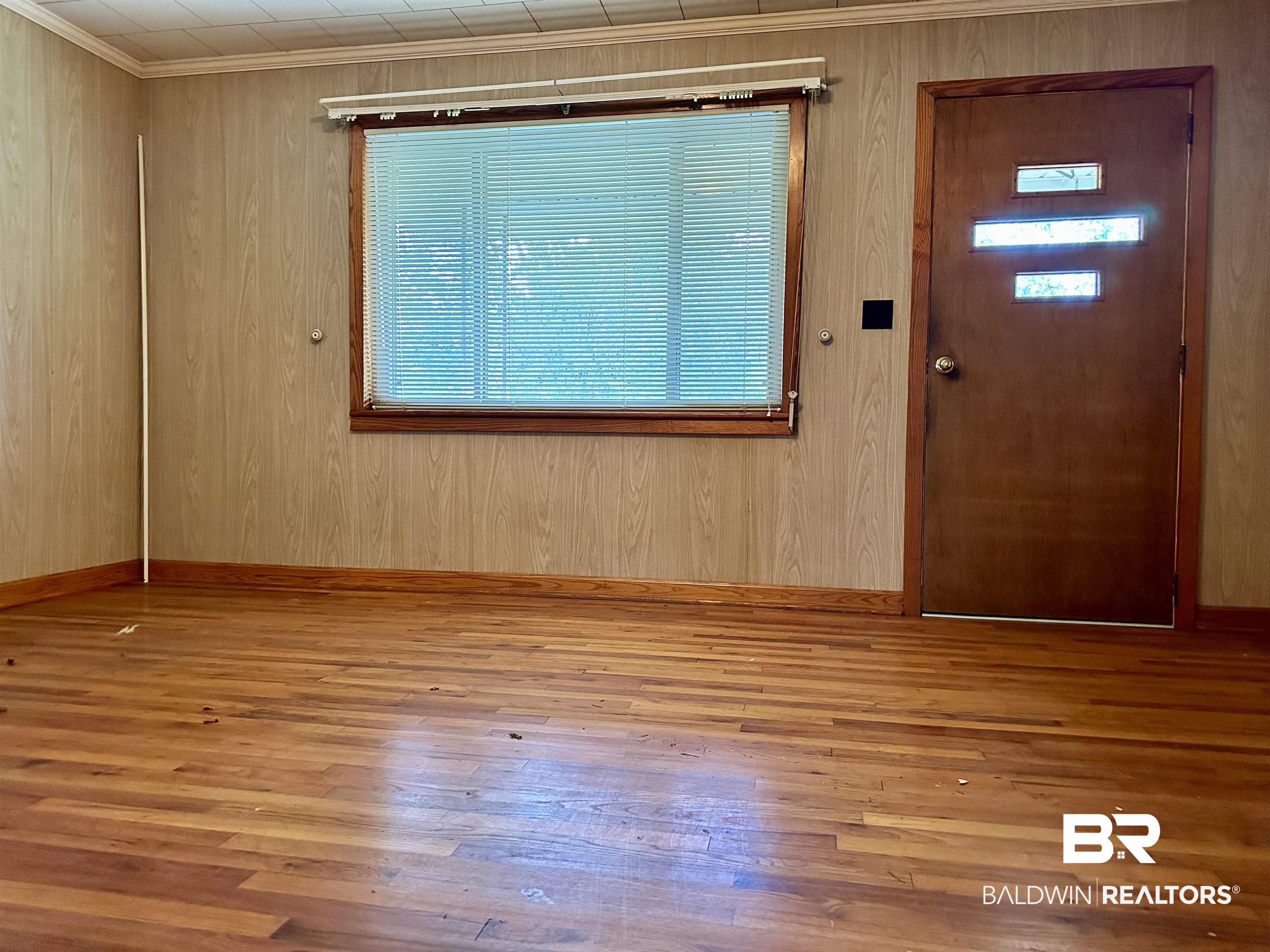 1081 Jay Road Brewton, AL 36426 - Photo 6 of 19 Foyer entrance with light wood-type flooring, ornamental molding, and wooden walls