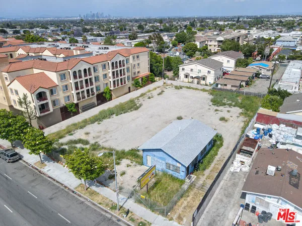 an aerial view of multiple houses with a yard